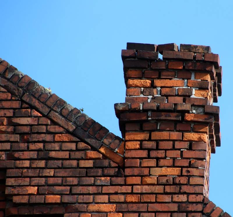 Damaged chimney on an San Diego home showing cracks and missing mortar